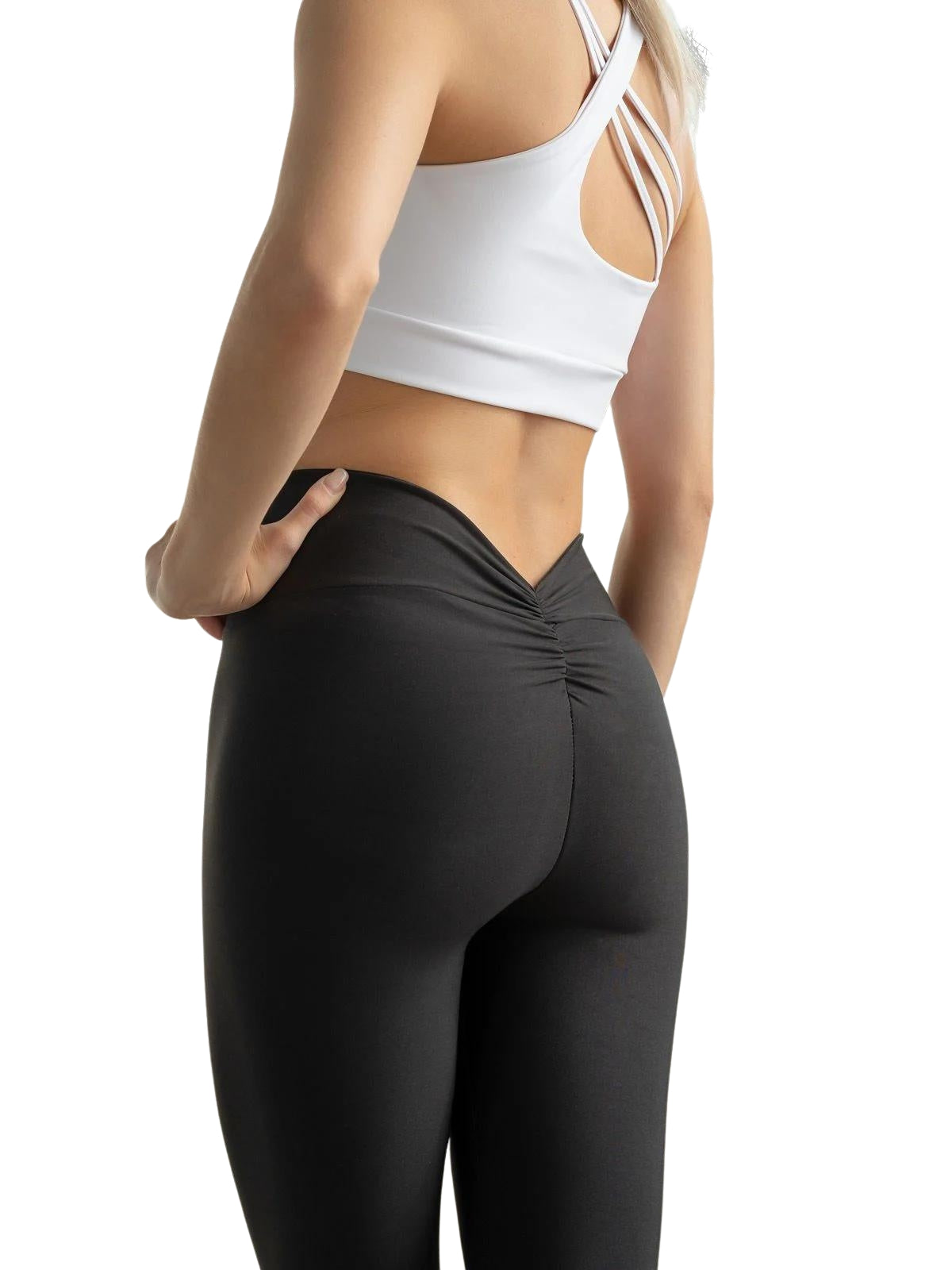Eine Frau, die Lisminas 406 VE Butt Scrunch Leggings in Schwarz und einen weißen Sport-BH trägt, präsentiert den V-Cut-Stil.