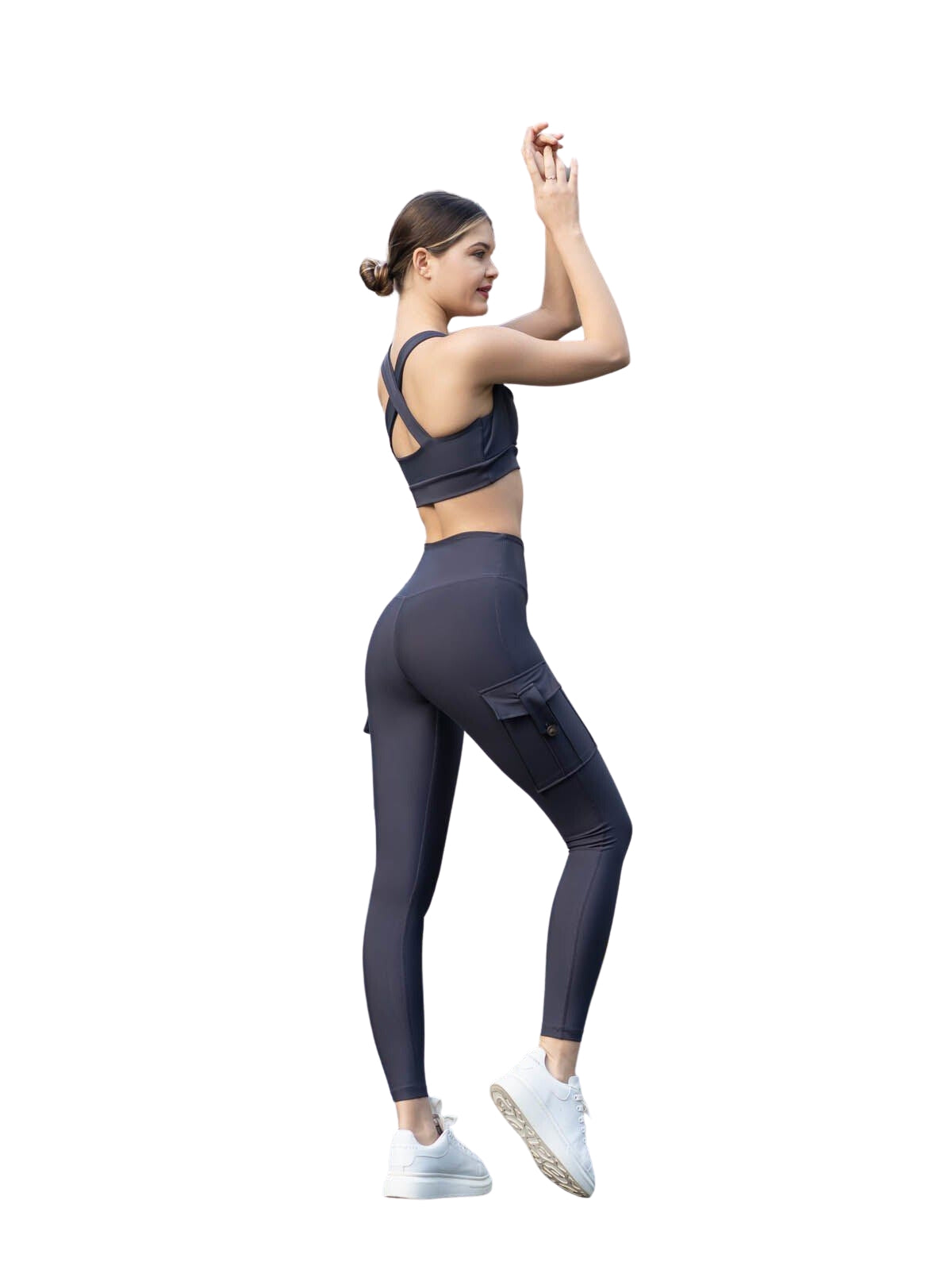 Frau in Lismina 317 Leggings mit Taschen in Anthrazit, weißen Turnschuhen, Arme erhoben, nach hinten gerichtet.