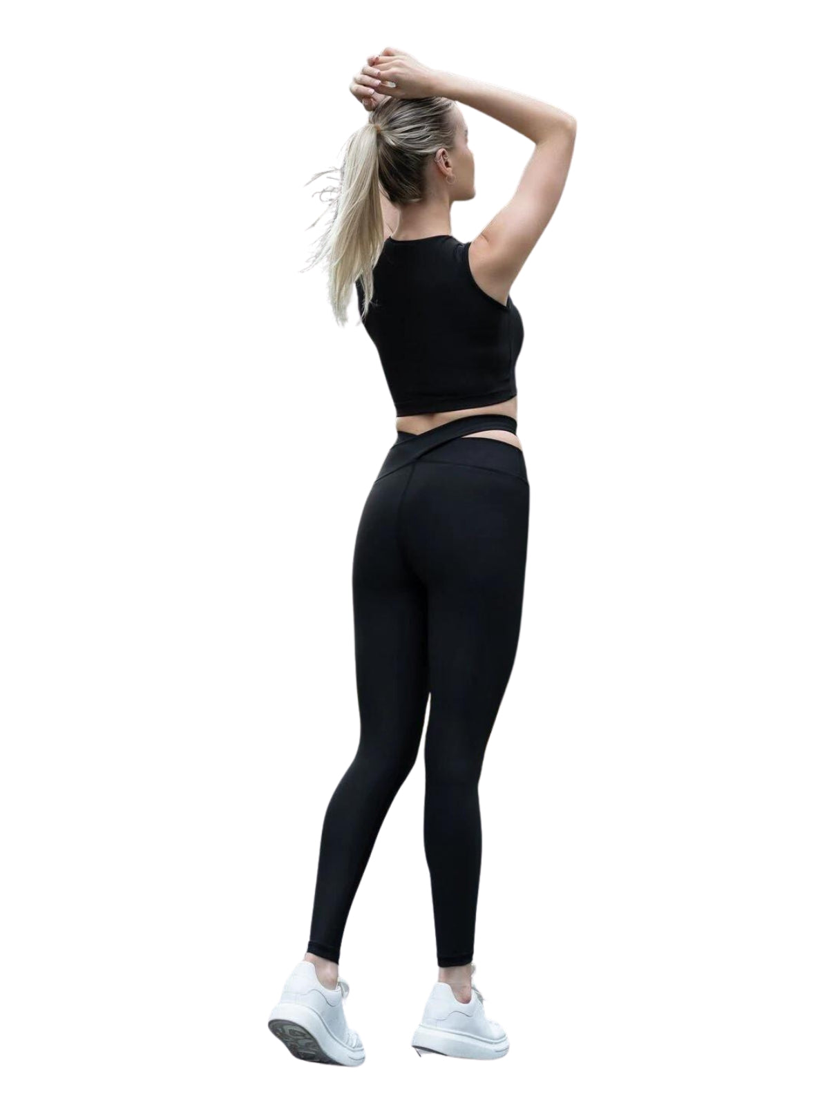 Frau in Lisminas 814 Black Extra High Waist Leggings, dehnt sich mit erhobenen Armen und trägt weiße Turnschuhe; bereit für Fitness.