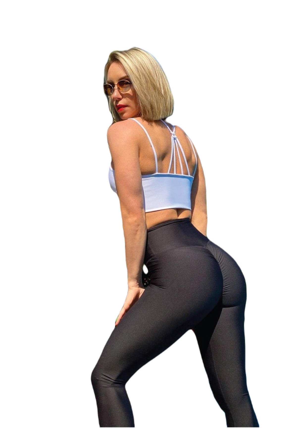 Die Person posiert seitlich in Lisminas weißem Sport-BH und 737 Scrunch Butt Leggings in Schwarz.