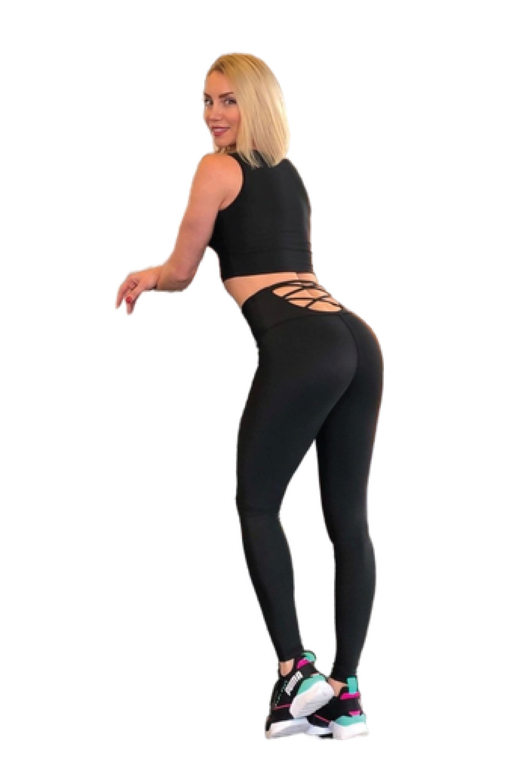 Eine Person in Lisminas 297 High Waist Leggings in Schwarz posiert seitlich und präsentiert das überkreuzte Rückendetail.